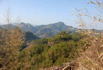 Wuyishan mountains in Fujian Province, China. Scenic view over the peaks of Wuyi mountains. A classic view of the hills from Roaring Tiger Rock. Wuyishan is a UNESCO World Heritage site in China.