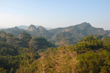 Wuyishan mountains in Fujian Province, China. Scenic view over the peaks of Wuyi mountains. A classic view of the hills from Roaring Tiger Rock. Wuyishan is a UNESCO World Heritage site in China.