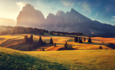 Fototapeta premium Stunning morning Scene. Majestic Moutain peak under sunlight, Alpe di Siusi valley during sunset. Amazing Nature Landscape. Awesome natural Background. Incredible colorful Scenery. Dolomites alps