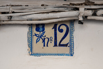 Ceramic number and symbols signs outside the house in Granada, Andalucia, South of Spain