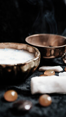 Milk and blue flowers in a bronze bowl.