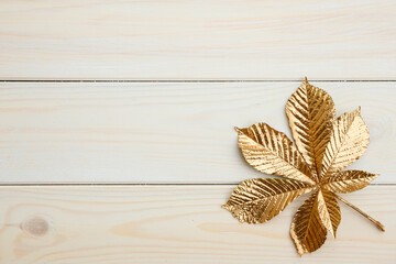 Golden chestnut leaf on white boards.