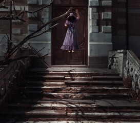 Woman soaring in the air in front of abandoned house. Horror scene of the Woman Ghost.
