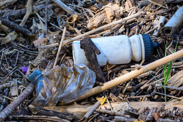 Obraz premium Pollution of plastics mixed with wood by the river