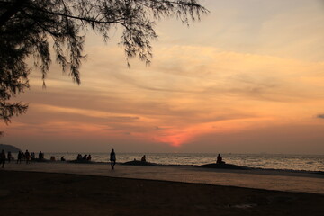 silhouette of a people on the beach at sunrise
