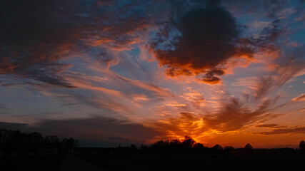 Beautiful sunset with dramatic clouds near Tabertshausen, Bavaria, Germany