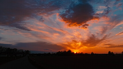Beautiful sunset with dramatic clouds near Tabertshausen, Bavaria, Germany