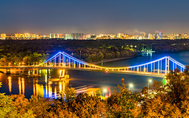 Fototapeta na wymiar Pedestrian bridge across the Dnieper River in Kiev, Ukraine