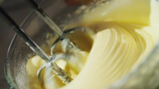Closeup of mixer or food processor mixing butter for use in baking pastry and desserts and cooking other dishes