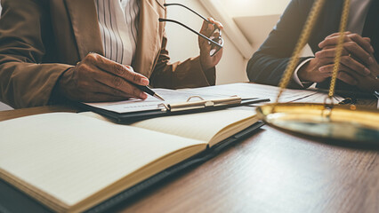 Judge gavel with Justice lawyers having team meeting at law firm background. Concepts of Law and...