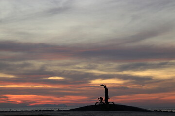 silhouette of a people on the beach at sunrise