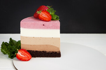 Piece of triple chocolate mousse cake with strawberryes, baking template, empty space