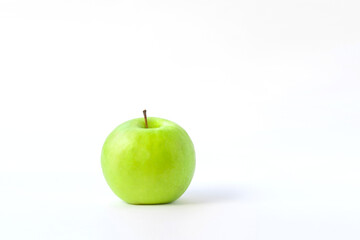 fresh green apple on clear solid and white background in studio light.