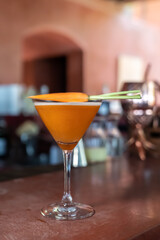 carrot mocktail are mixed and ready to serve on red bar.