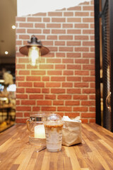 Take away Latte with Brick background on the wood table