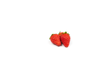 three isolated fresh strawberries on the pure white backgroud in studio light. Clipping path.