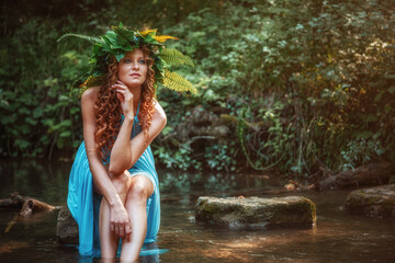Fototapeta premium a beautiful young woman celebrates in the woods the solstice day