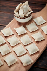 raw dumplings on teh wooden board