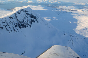 beautiful and majestic snowy mountain landscape with ocean in the background