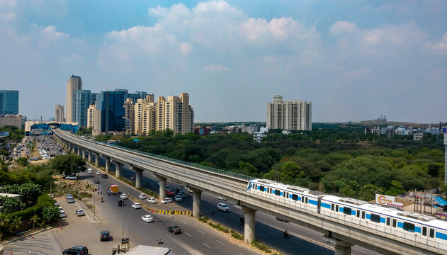 Aerial shot of Rapid metro tracks in urban areas of Delhi NCR, Gurgaon, Noida with metro running on the tracks. A very useful addition to existing DMRC rail network