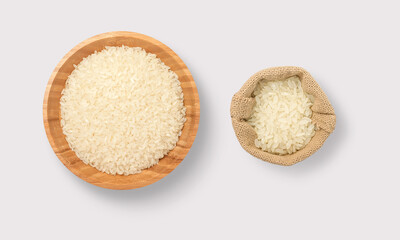 Fototapeta na wymiar Rice in a wooden bowl and sack on a white background