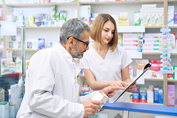 Fototapeta na wymiar Two pharmacist checking product in folder.