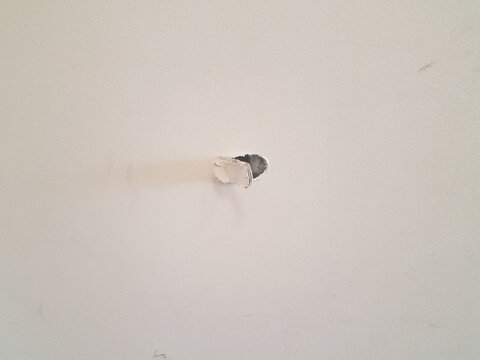 small hole damage in a drywall wall