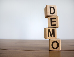 Concept word 'demo' on cubes on a beautiful wooden table. White background. Business concept. Copy...