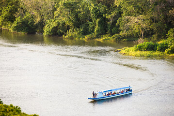 Landscape Photography Little boat passing by San Juan River. Nicaragua Tropical Central America.