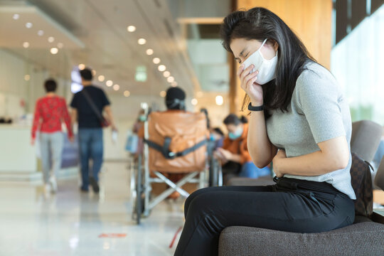 Sick Asian Female Face Mask Protection Cough And Sneeze With High Temperature Headache Feel Bad Corona Virus Covid 19 Infected Sit Wait At Hospital Clinic Waiting Area