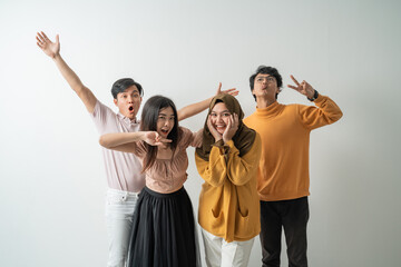 group of young Asian people happy to celebrate when looking at the camera with an isolated...