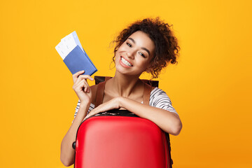 Cheerful African Girl Showing Flight Tickets Posing Over Yellow Background