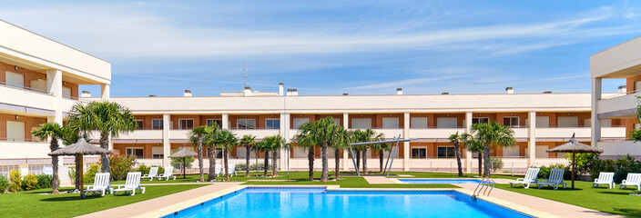 Modern residential complex with swimming pool, rented apartment summer holidays, new home buying, loan and lending concept, panoramic image, Spain, Costa Blanca. España