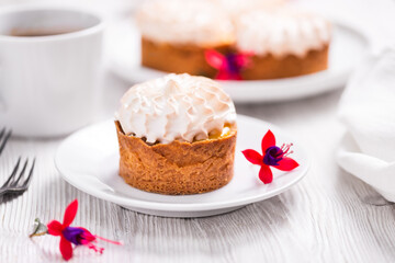 Sweet tart with cream on wooden table
