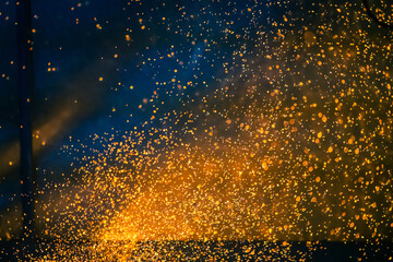 Flame and fire spark with bokeh on dark abstract background