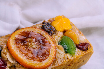 Fresh homemade fruit cake with juicy candied fruits topping