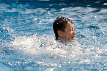 Young boy swimming in pool