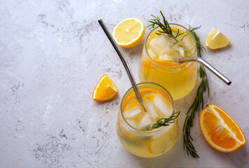 Cold lemonade with citrus in glass glasses with ice