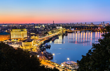 Fototapeta na wymiar Cityscape of Kiev with the Dnieper at sunset. Ukraine