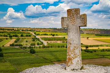 Old christian cross above the historical temple complex of old Orhei or Orheiul Vechi, Moldova. July2019.