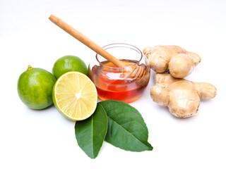 Ingredients for juice drinks or tea with honey, lime lemon and ginger isolated on white background.