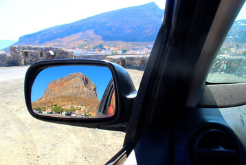 Naklejka premium Gova in the sea is reflected in the mirror of a car. Monemvasia. Greece