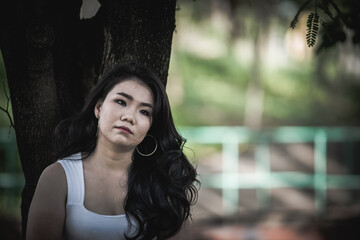 Beautiful thai woman very sad from unrequited love,She rethink and think over about love,vintage style,dark tone,broken heart,asian girl think a lot because she fat