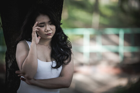 Beautiful thai woman very sad from unrequited love,She rethink and think over about love,vintage style,dark tone,broken heart,asian girl think a lot because she fat