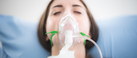 woman patient wearing oxygen mask sleeping on hospital bed, Pre oxygenation for general anesthesia....