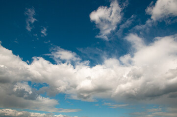 Blue sky on a Sunny summer day. large white clouds cover the sun.