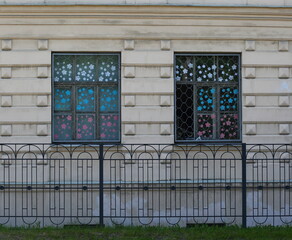 Barred Windows of a building behind a metal fence