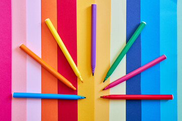 Rainbow of colored pencils on a colorful background
