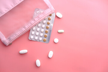 birth control pills on pink background, Top view 