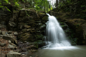 Fototapeta na wymiar Beautiful waterfall among rocks in forest, Obidza, Malopolskie, Poland.
